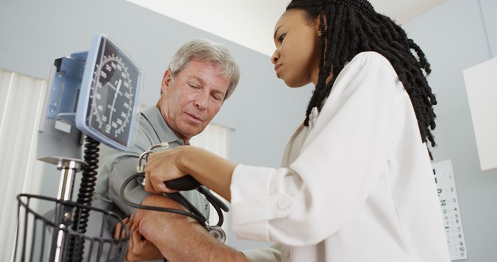 Doctor taking a man's blood pressure