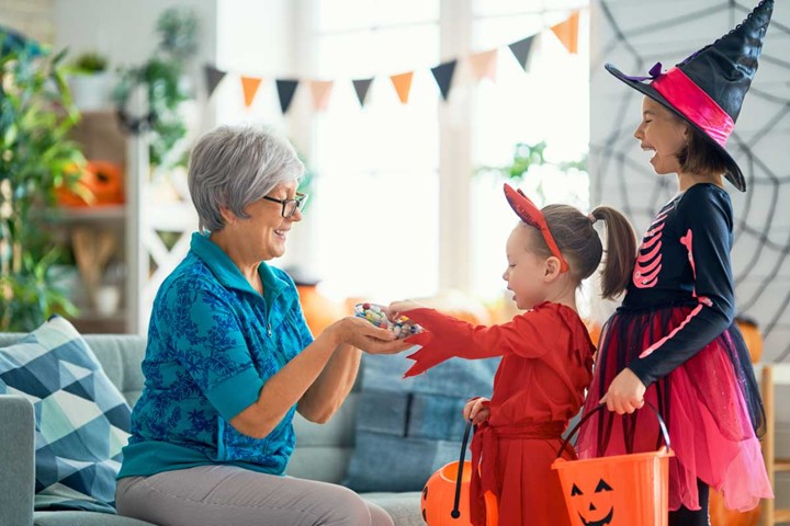 Elder woman with children on Halloween