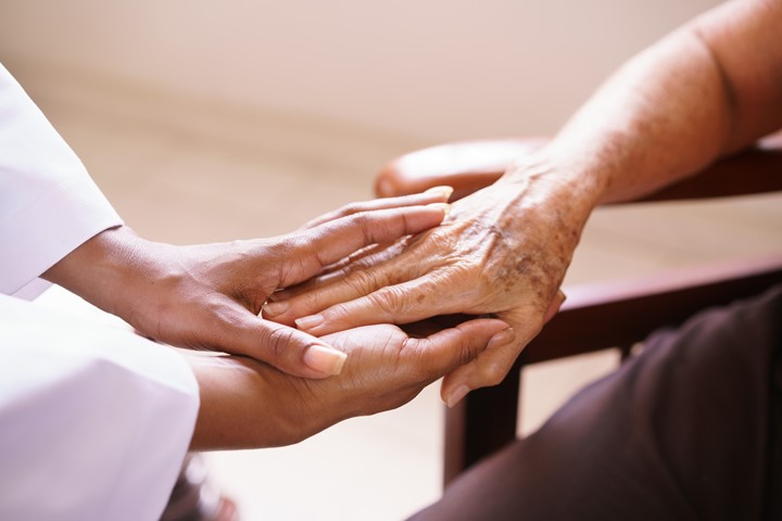 Closeup photo of two people holding hands.