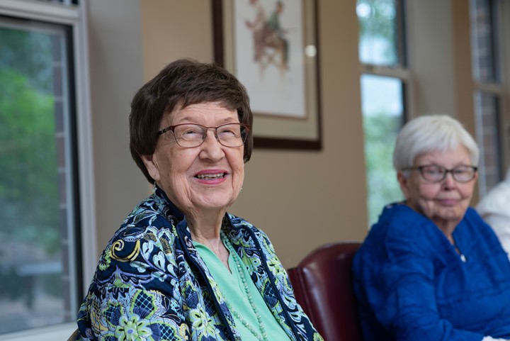 Two older women sitting in a class