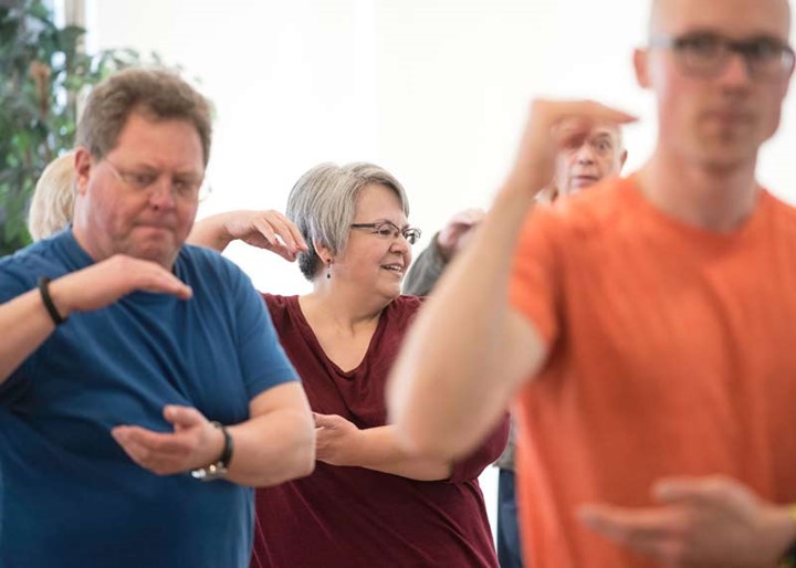 Photo of four people doing tai chi poses