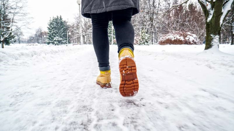 Woman walking in snow.