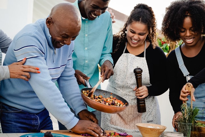 Photo of four people cooking.