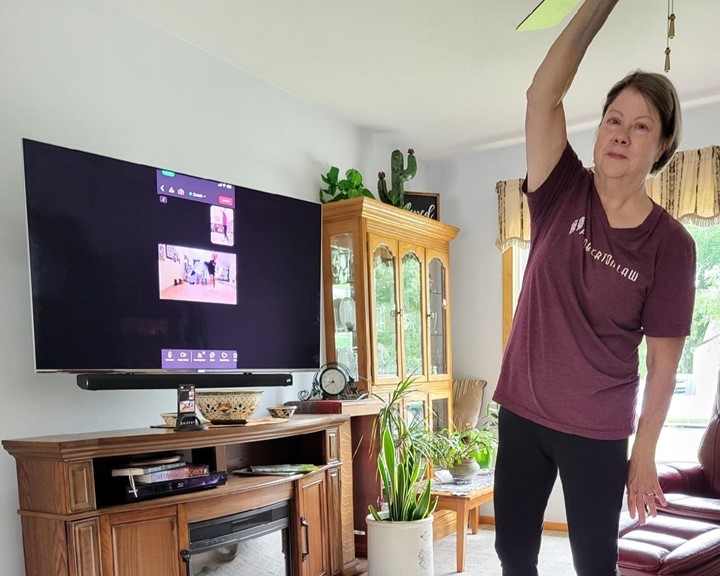 Karel Odegard exercising in front of her television