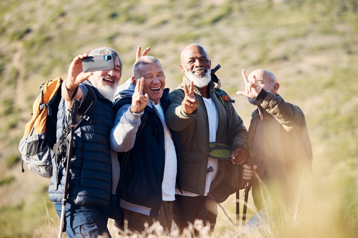 a photo of four people taking a selfie during a hike.