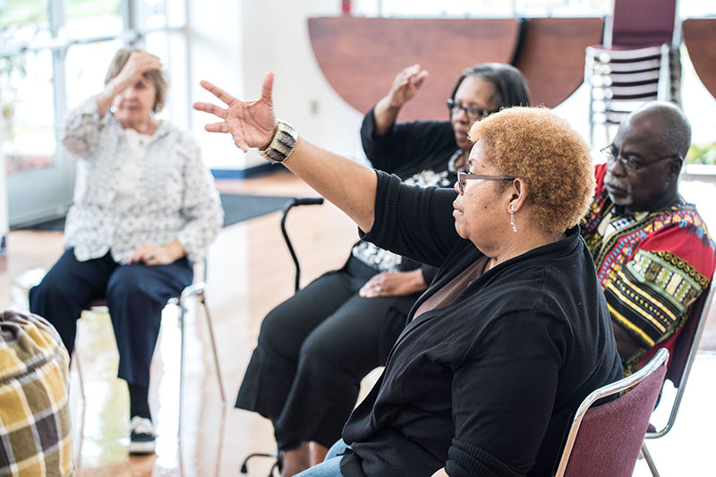 Photo of four people seated during an exercise class