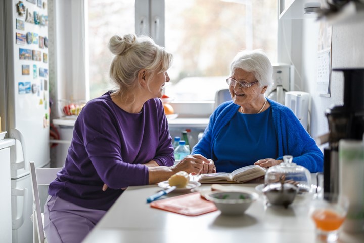 Woman sitting with mother at a table