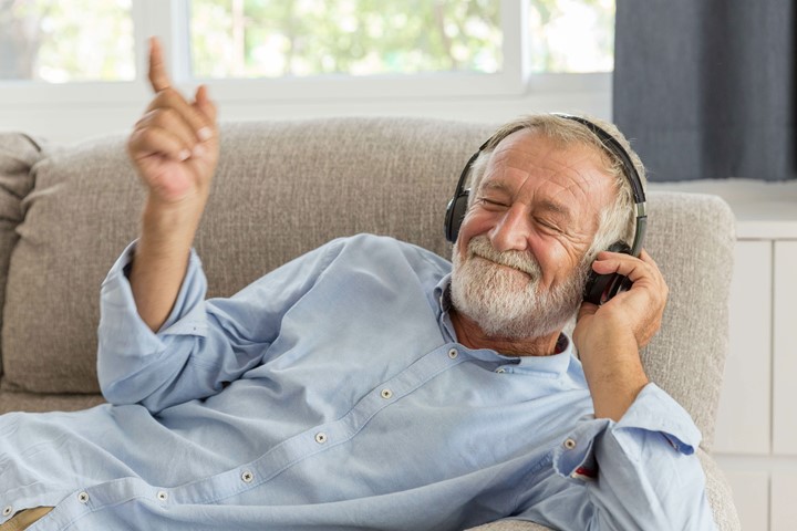 Older man listening to music with headphones