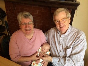 Teresa and her husband with their grandson