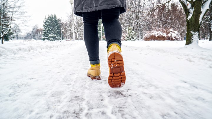 Photo of someone walking down a snowy path.