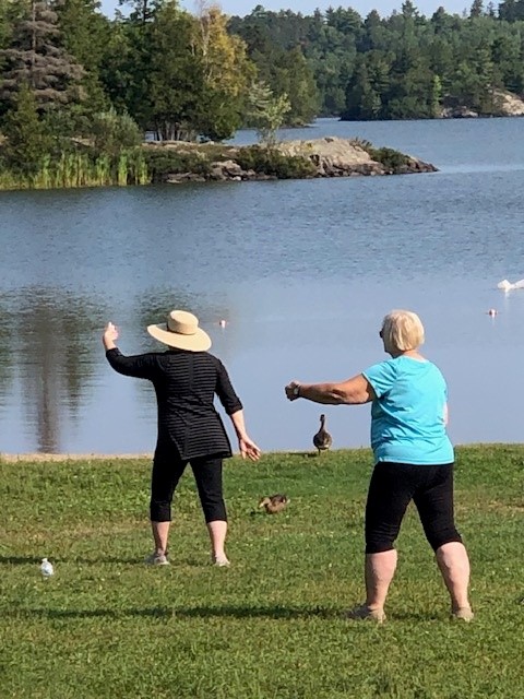 2 participants in Tai Ji Quan class by the lake