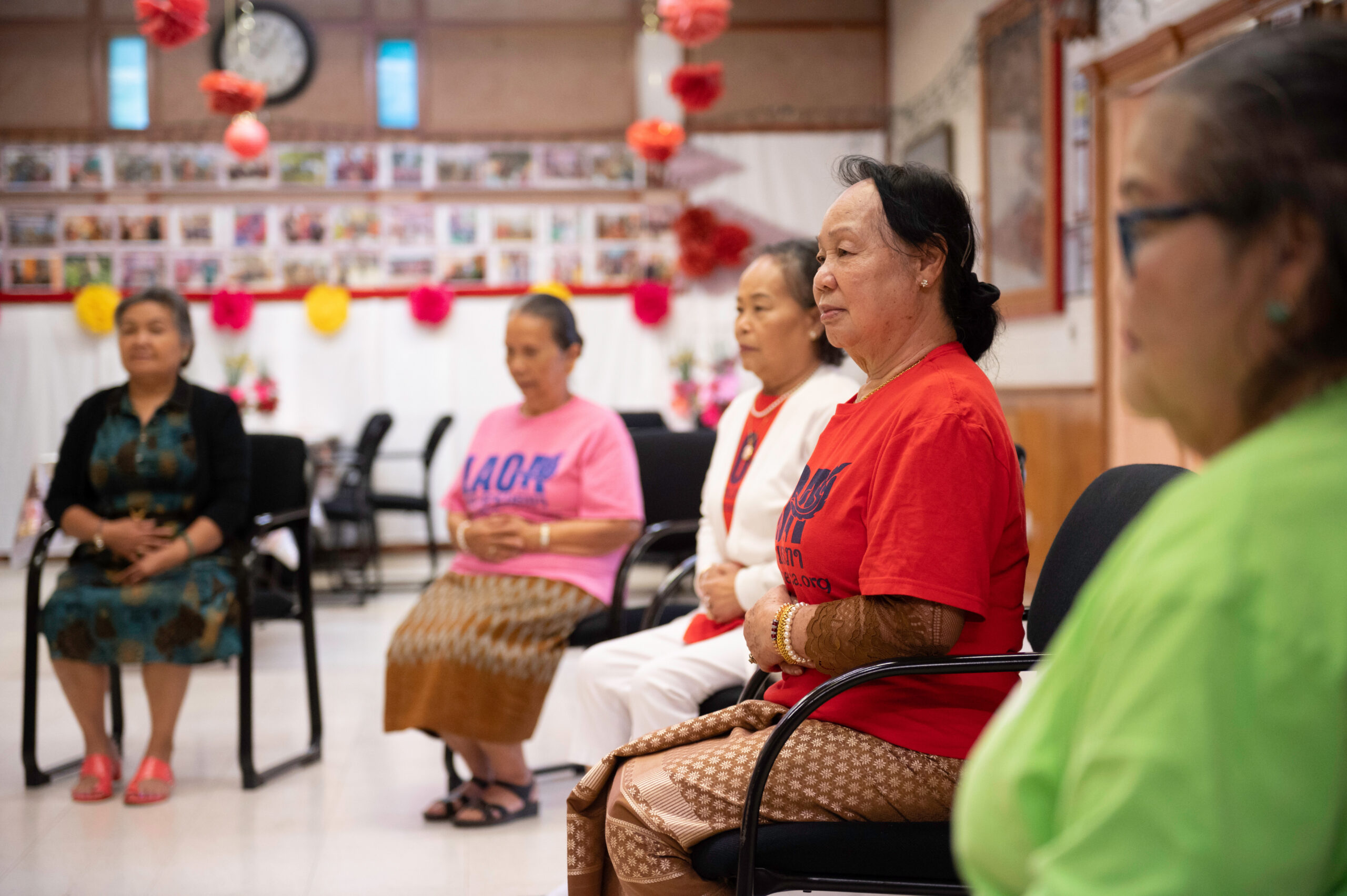 Five older adults sitting in a circle.