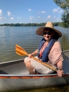 Photo of Adrienne Wiggins in a canoe on a lake.